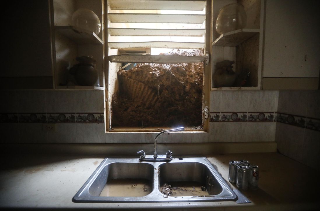 Mud from a landslide blocks the kitchen window of the Reyes family more than two weeks after Hurricane Maria hit the island, on October 9, 2017 in Jayuya, Puerto Rico. <br/>